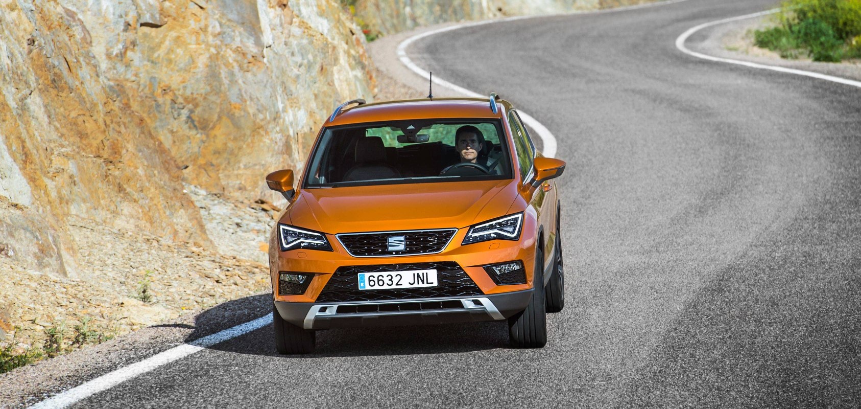 SEAT Arona front view on road color orange eclipse