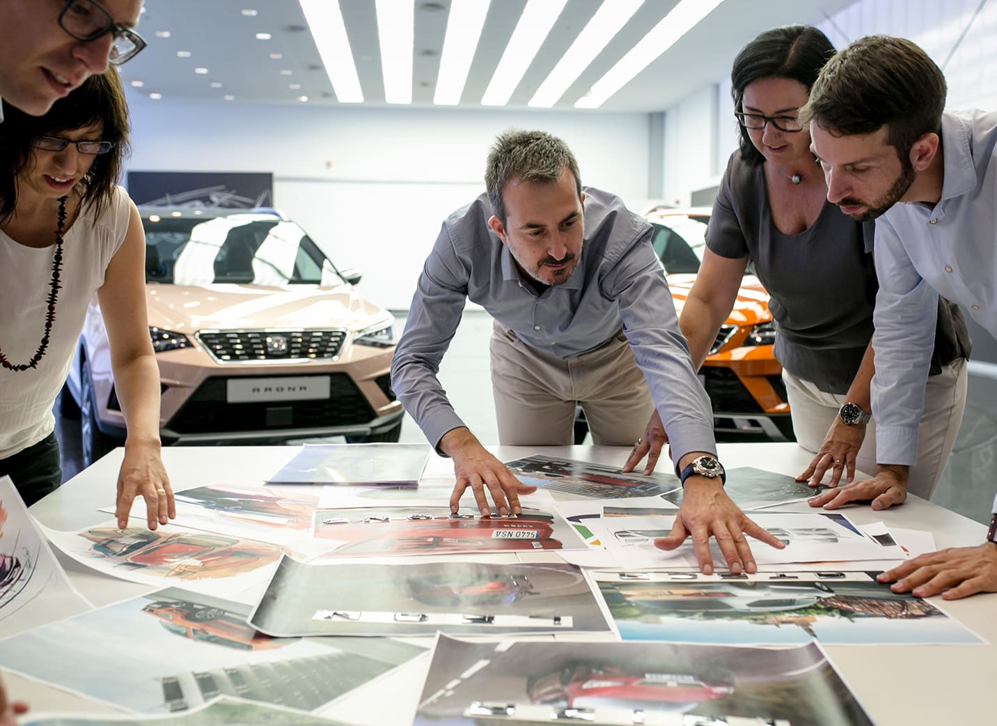 SEAT design team analysing images laid out on a table