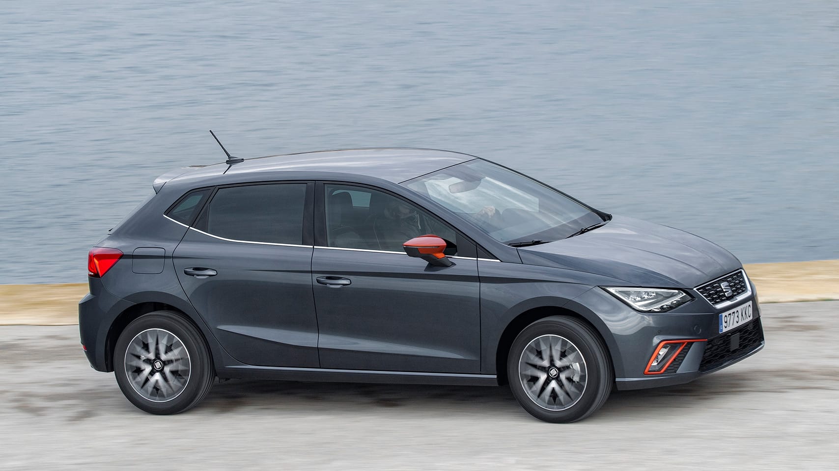 SEAT Ibiza parked outside sea landscape behind