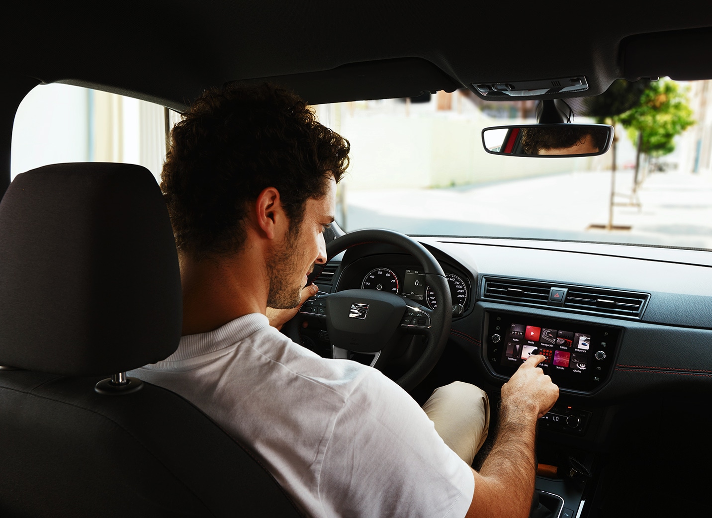 SEAT new car services and maintenance – Side view of woman driving a red new car SEAT