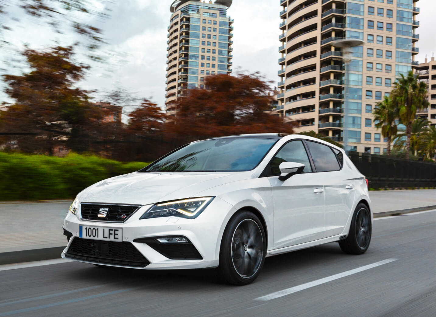 SEAT new car services and maintenance – new SEAT Leon white city car driving