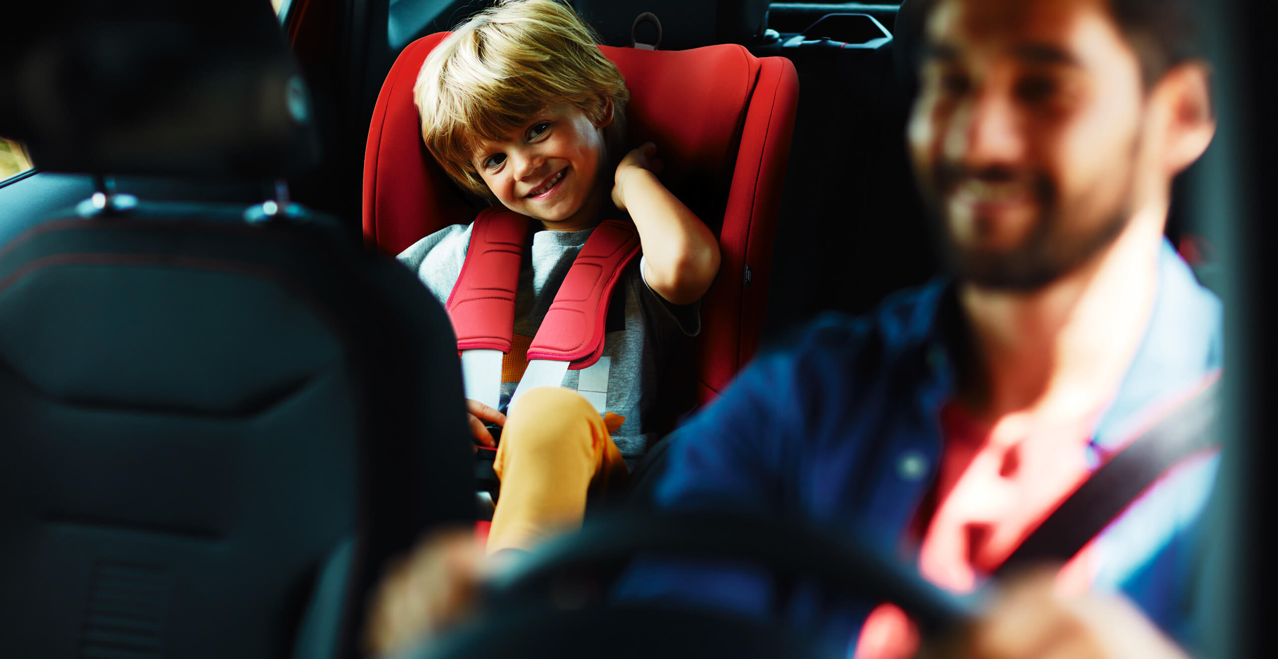 SEAT new car services warranty extension  maintenance – Child in child seat with father driving the car interior view