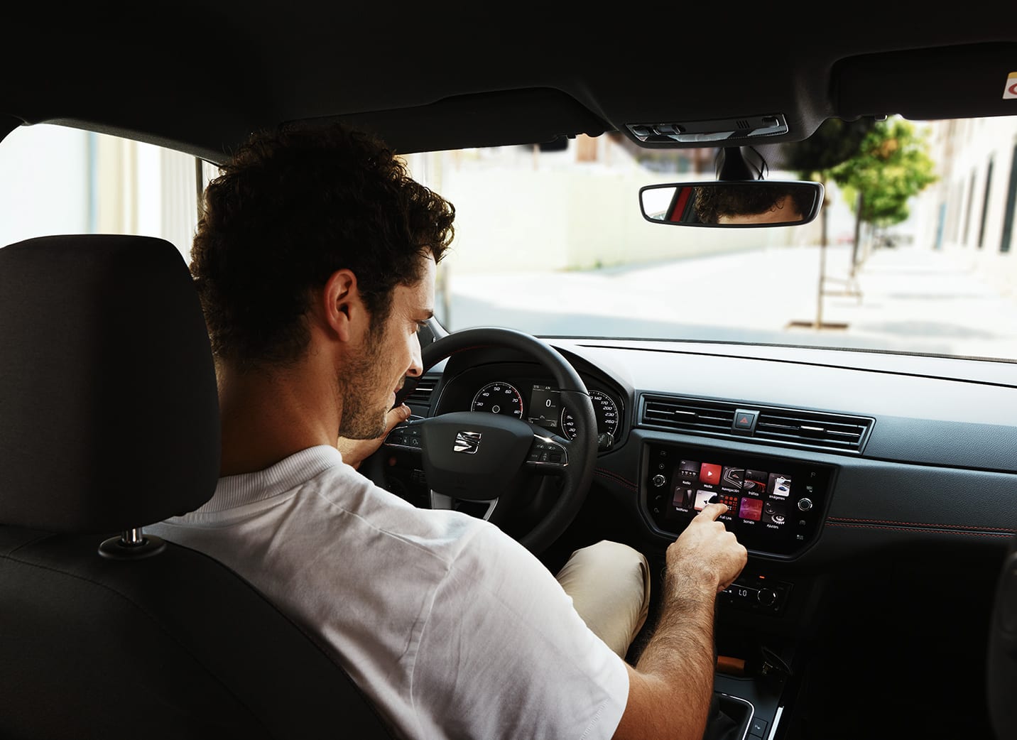 Man playing songs in SEAT car