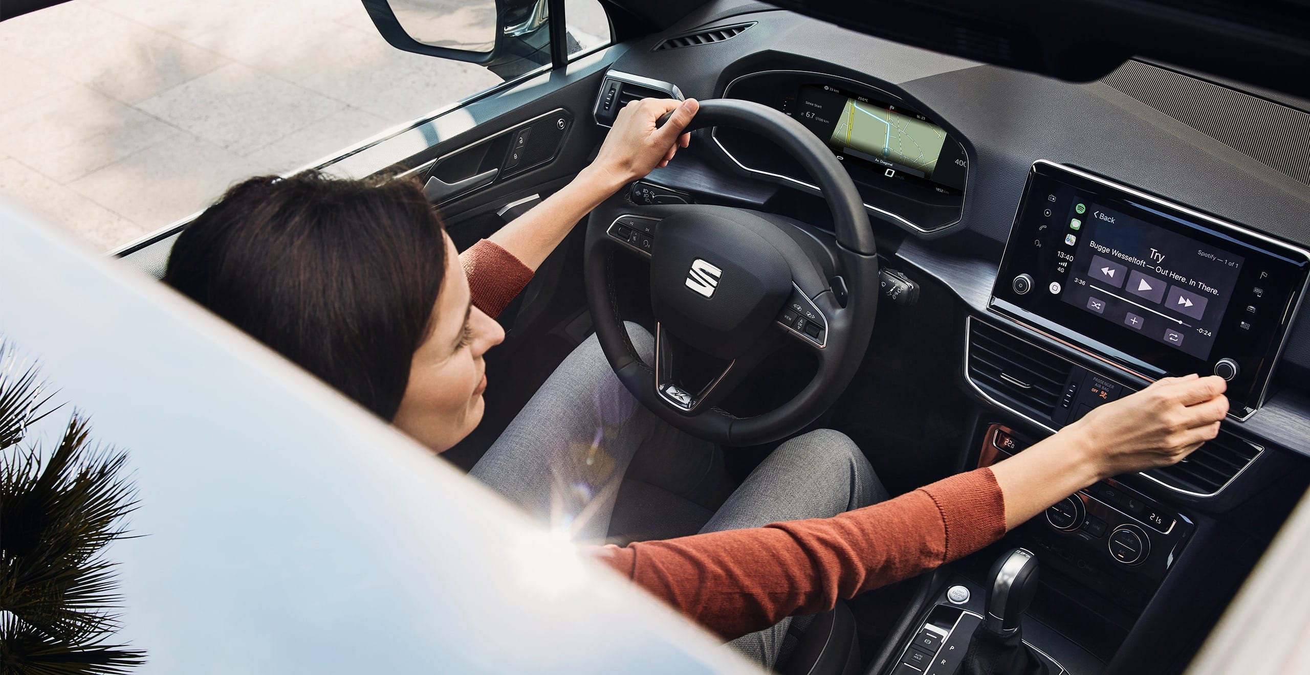 Woman using Amazon Alexa in SEAT car